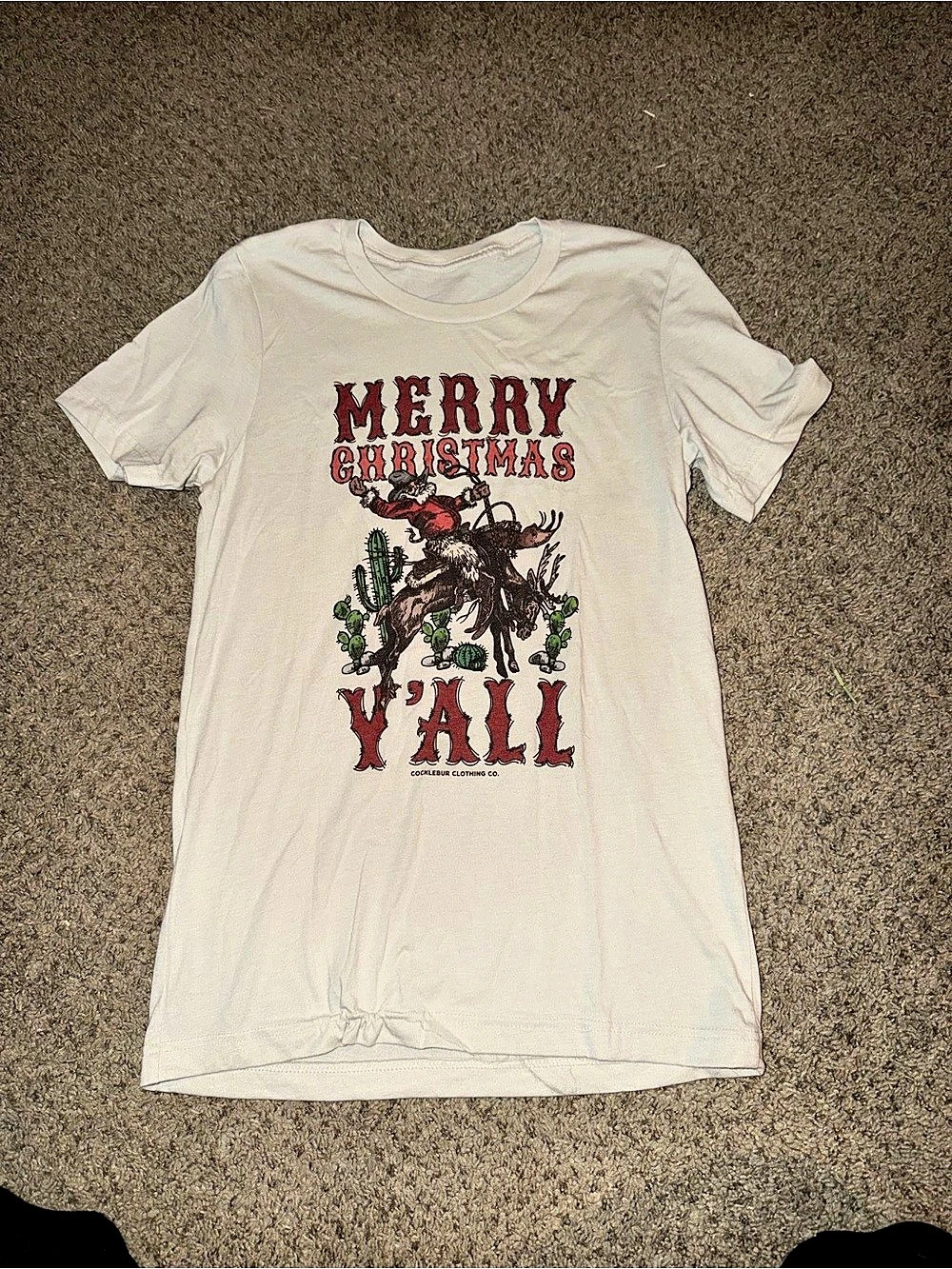 Cocklebur Clothing Co. Merry Christmas Y'all Graphic Tee.